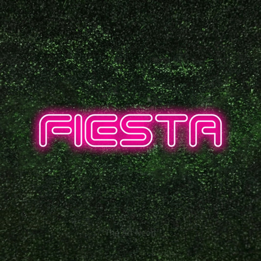 Hot pink outline-style LED neon sign reading "Fiesta" against a textured green moss wall for party décor