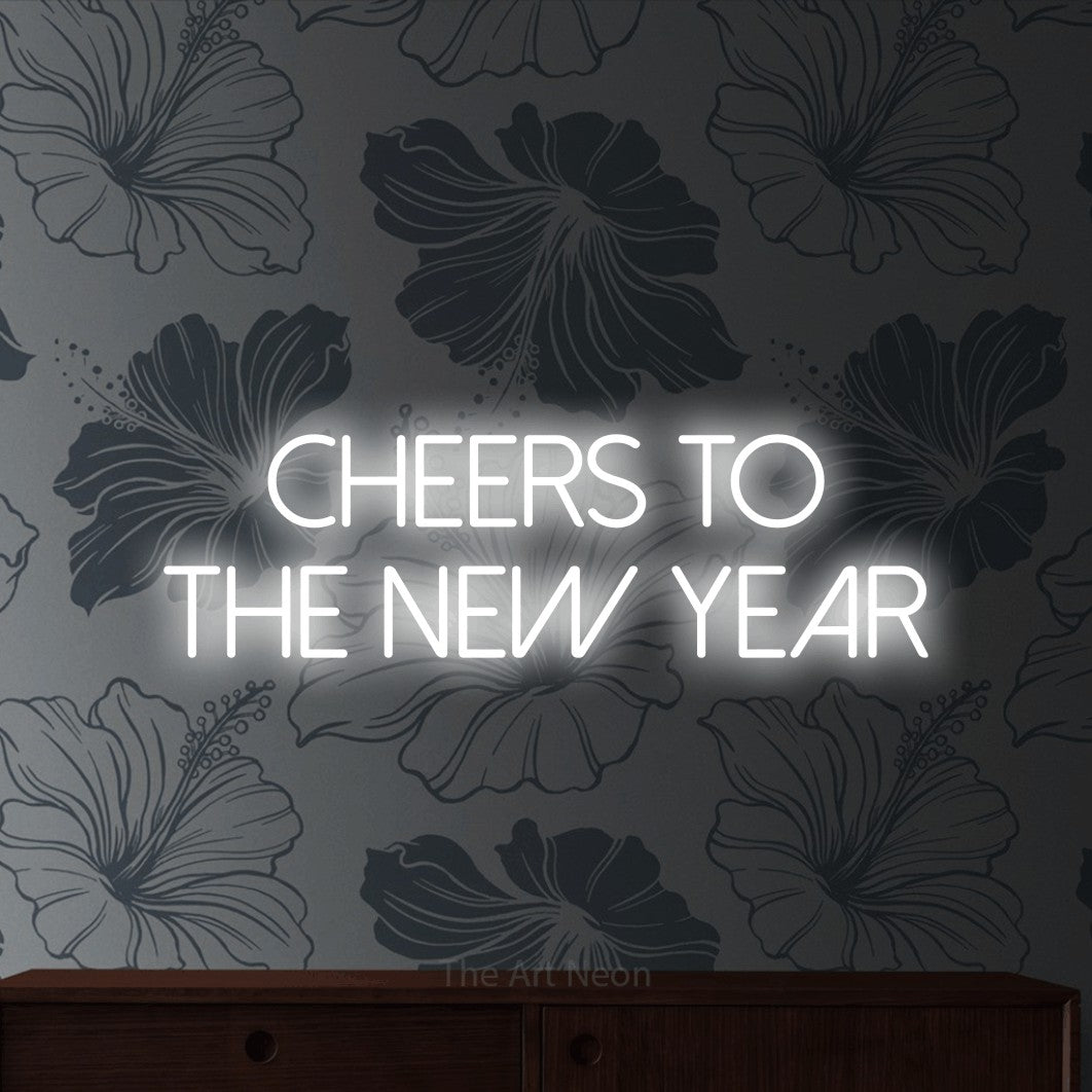 Cool white LED neon sign reading "Cheers to the New Year" against grey floral wallpaper for party décor