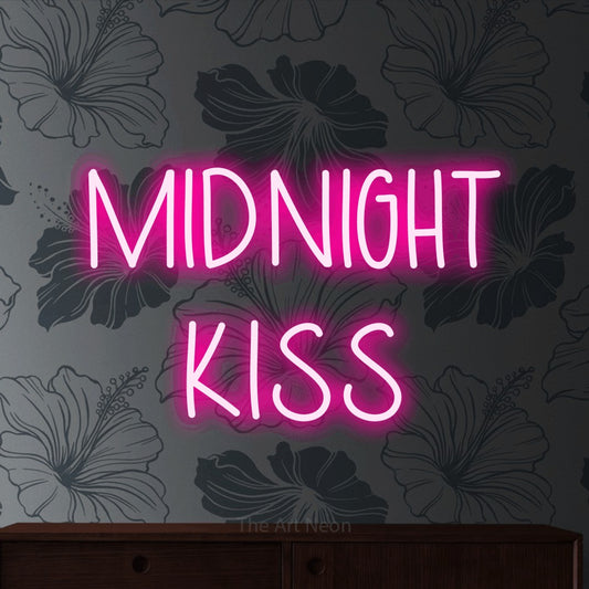 Hot pink LED neon sign reading "Midnight Kiss" against grey floral wallpaper for party décor