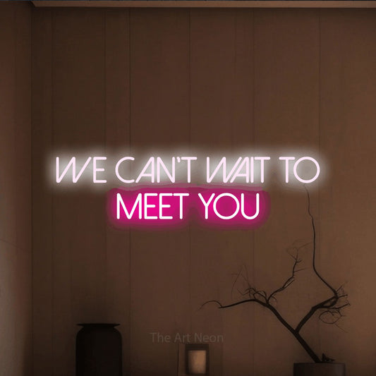 Hot pink and cool white LED neon sign reading "We Can't Wait to Meet You" against a warm brown wall