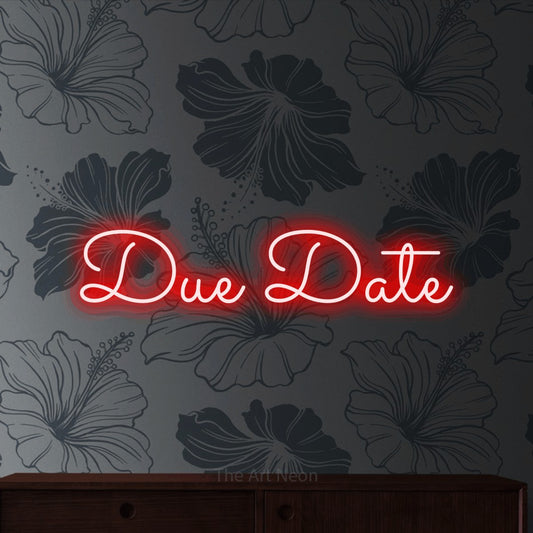 Red LED neon sign reading "Due Date" against grey floral wallpaper