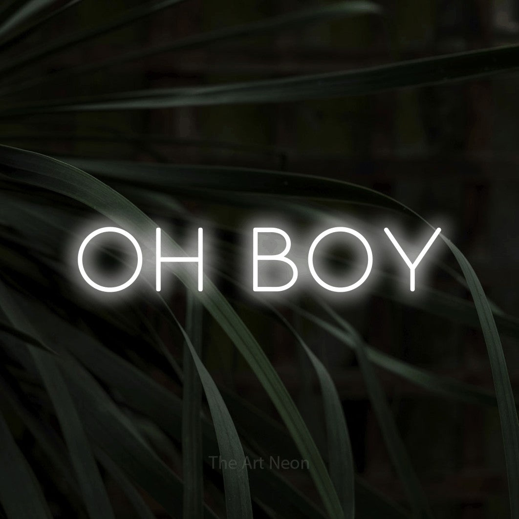 Cool white LED neon sign reading "Oh Boy" against dark tropical leaves