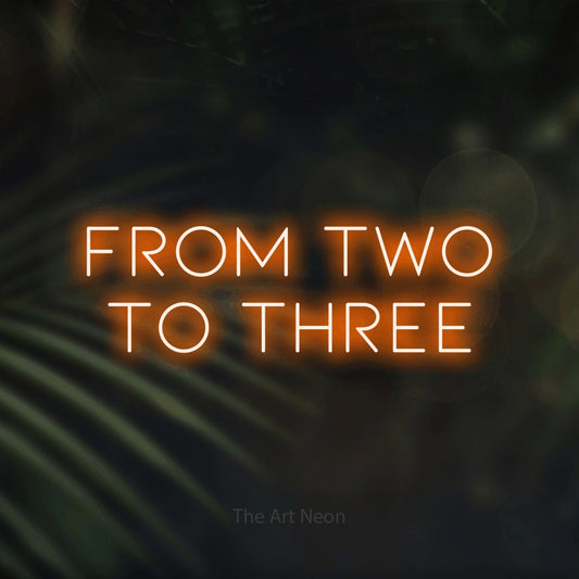 Orange LED neon sign reading "From Two to Three" against dark blurred palm leaves