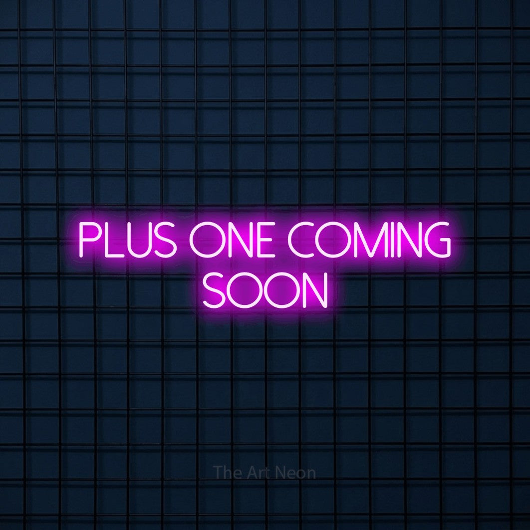 Enseigne néon à DEL à lumière rose, affichant « Plus One Coming Soon » sur un mur carrelé bleu foncé