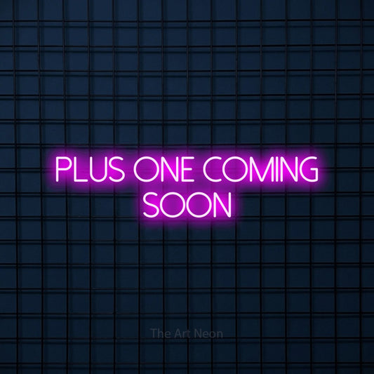 Pink LED neon sign reading "Plus One Coming Soon" against a dark blue tiled wall