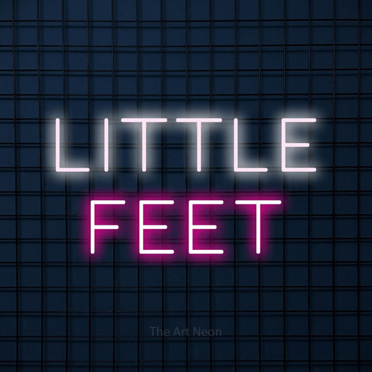Hot pink and cool white LED neon sign reading "Little Feet" against a dark blue tiled wall