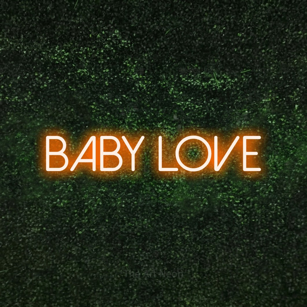 Enseigne néon à DEL à lumière orange, affichant « Baby Love » sur un mur texturé de mousse verte
