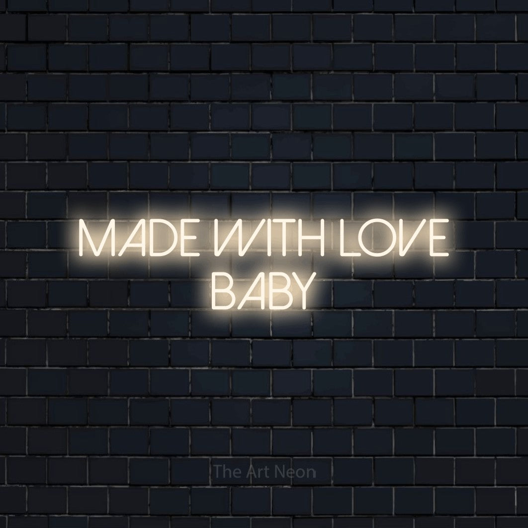 Warm white LED neon sign reading "Made with Love Baby" against a dark navy brick wall