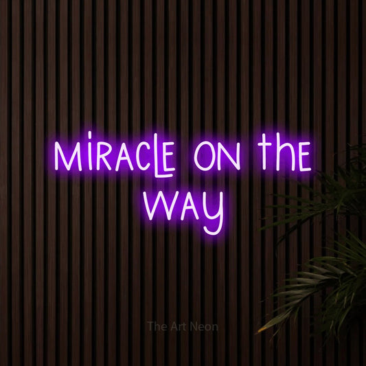 Purple LED neon sign reading "Miracle on the Way" against dark wooden slats