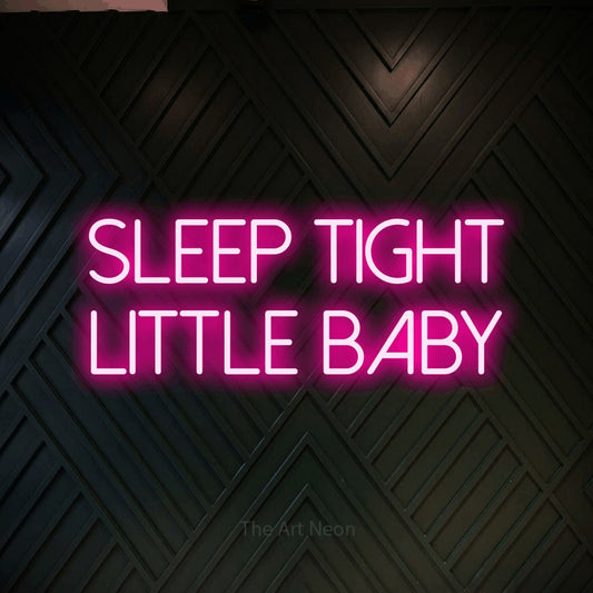 Hot pink LED neon sign reading "Sleep Tight Little Baby" against a dark geometric wood wall