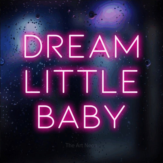 Hot pink LED neon sign reading "Dream Little Baby" against a dark blue bokeh background