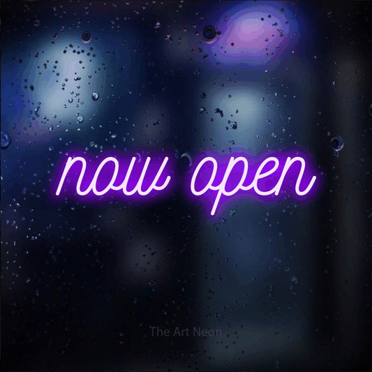 Purple script-style LED neon sign reading "Now Open" against a dark blue bokeh background for restaurant décor