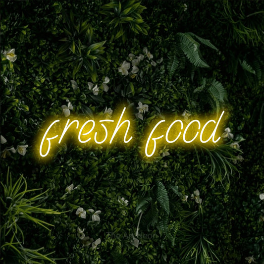 Yellow LED neon sign reading "Fresh Food" against a leafy green wall for restaurant décor