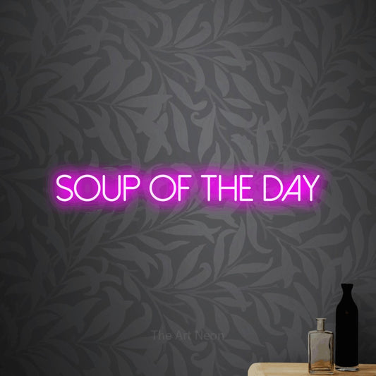 Pink LED neon sign reading "Soup of the Day" against light grey floral wallpaper for restaurant décor