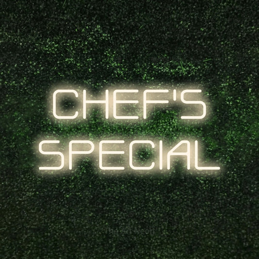 Warm white LED neon sign reading "Chef's Special" against a textured green moss wall for restaurant décor