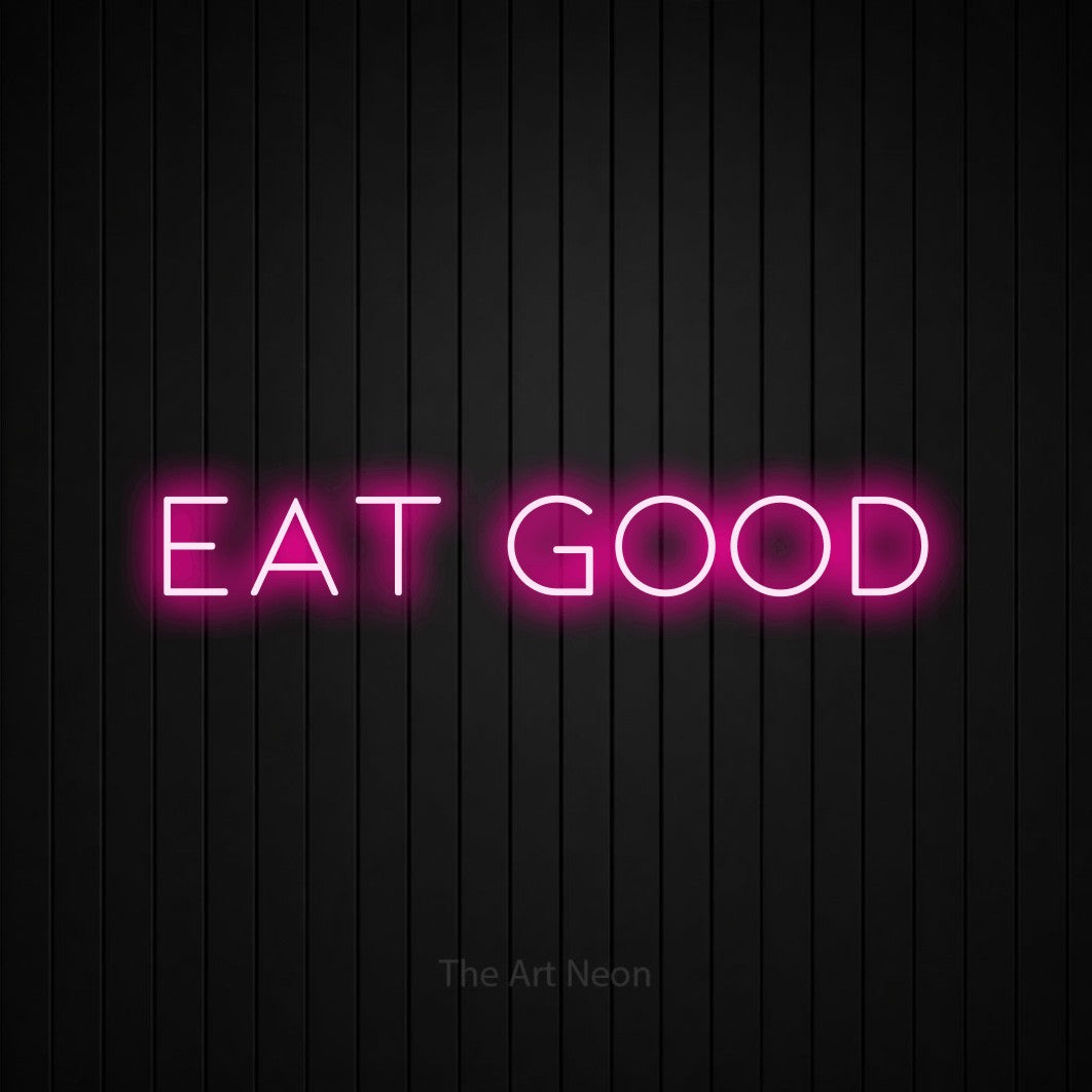 Hot pink LED neon sign reading "Eat Good" against a black vertical slat wall for restaurant décor