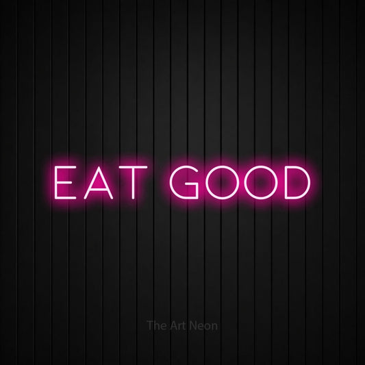 Hot pink LED neon sign reading "Eat Good" against a black vertical slat wall for restaurant décor