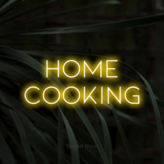 Yellow LED neon sign reading "Home Cooking" against dark tropical leaves for restaurant décor
