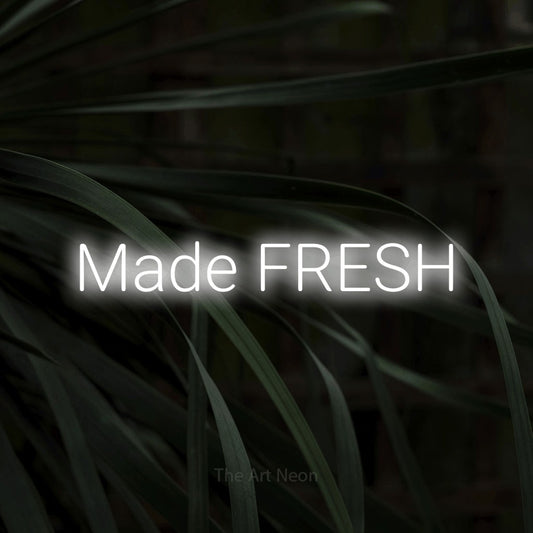 Cool white LED neon sign reading "Made Fresh" against dark tropical leaves for restaurant décor