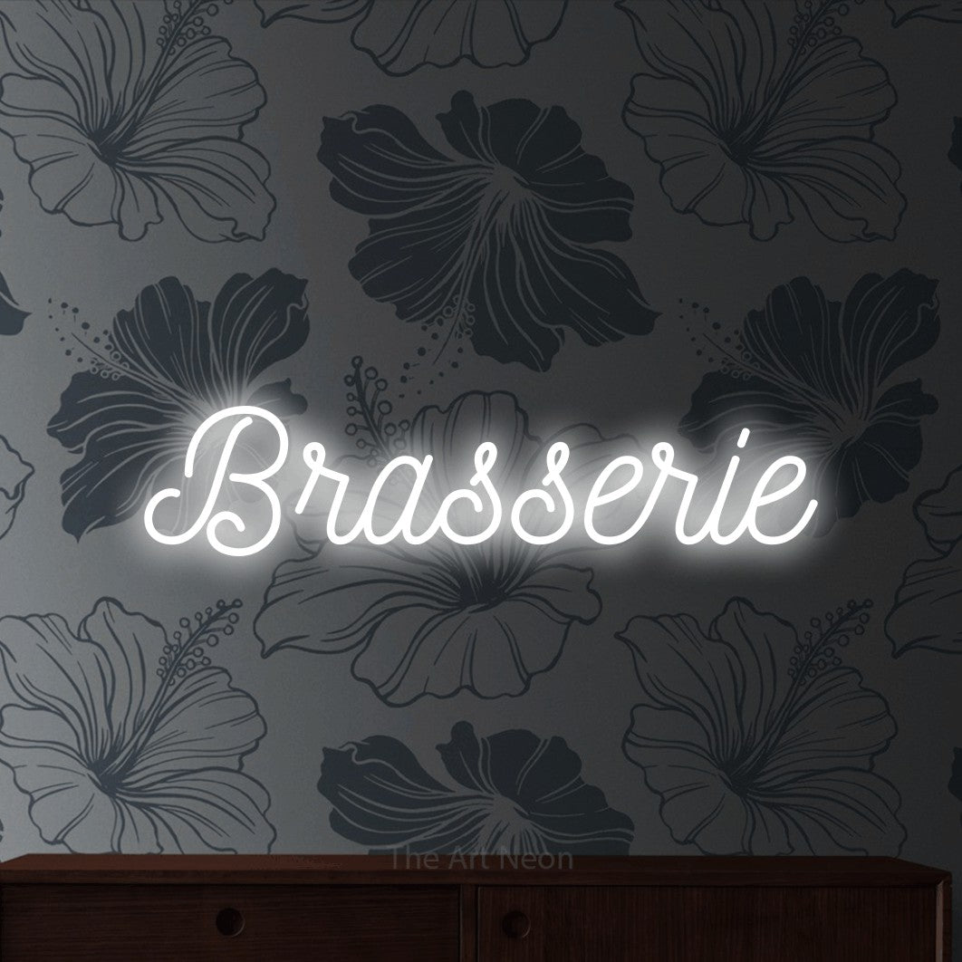 Cool white script-style LED neon sign reading "Brasserie" against grey floral wallpaper for restaurant décor