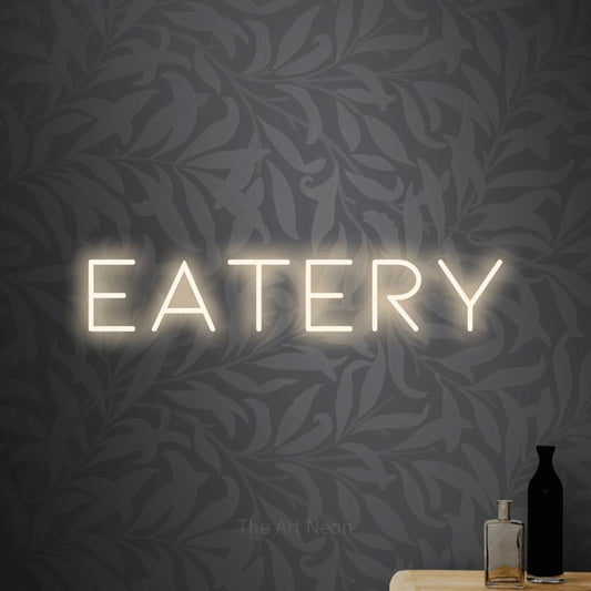 Warm white LED neon sign reading "Eatery" against light grey floral wallpaper for restaurant décor