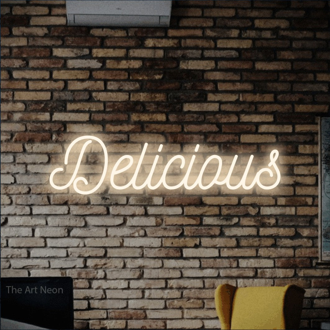 Warm white script-style LED neon sign reading "Delicious" against a rustic brick wall for restaurant décor