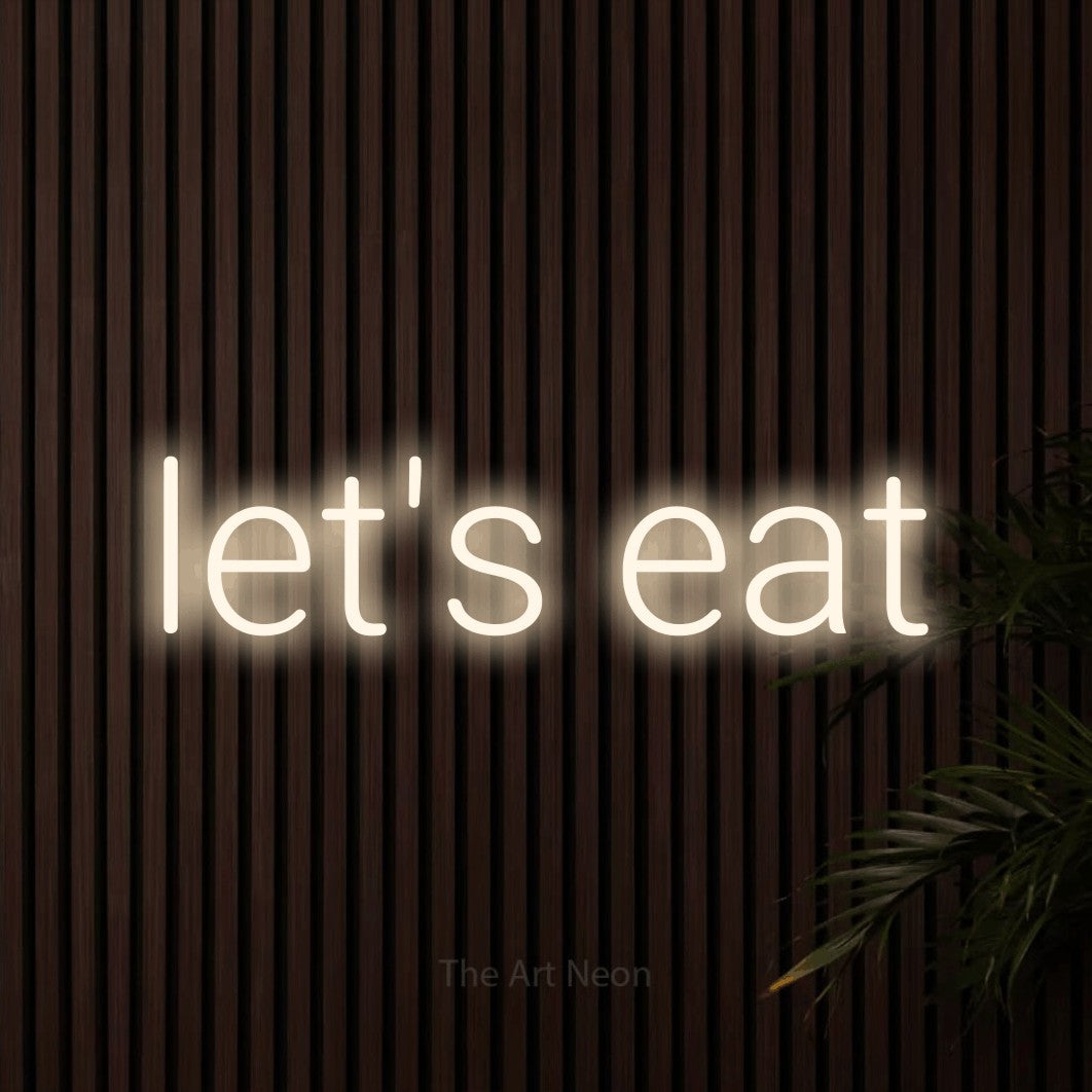 Warm white LED neon sign reading "Let's Eat" against dark wooden slats for restaurant décor