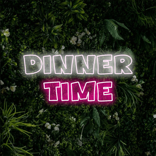 Hot pink and cool white outline-style LED neon sign reading "Dinner Time" against a leafy green wall for restaurant décor
