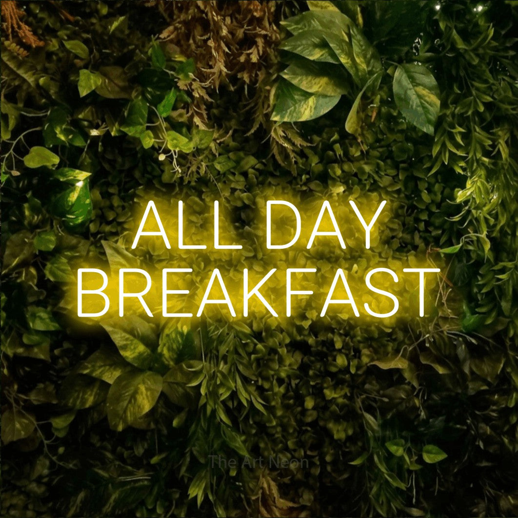 Yellow LED neon sign reading "All Day Breakfast" against a textured moss and foliage wall for restaurant décor
