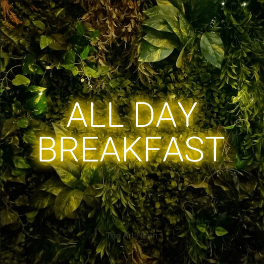 Yellow LED neon sign reading "All Day Breakfast" against a textured moss and foliage wall for restaurant décor