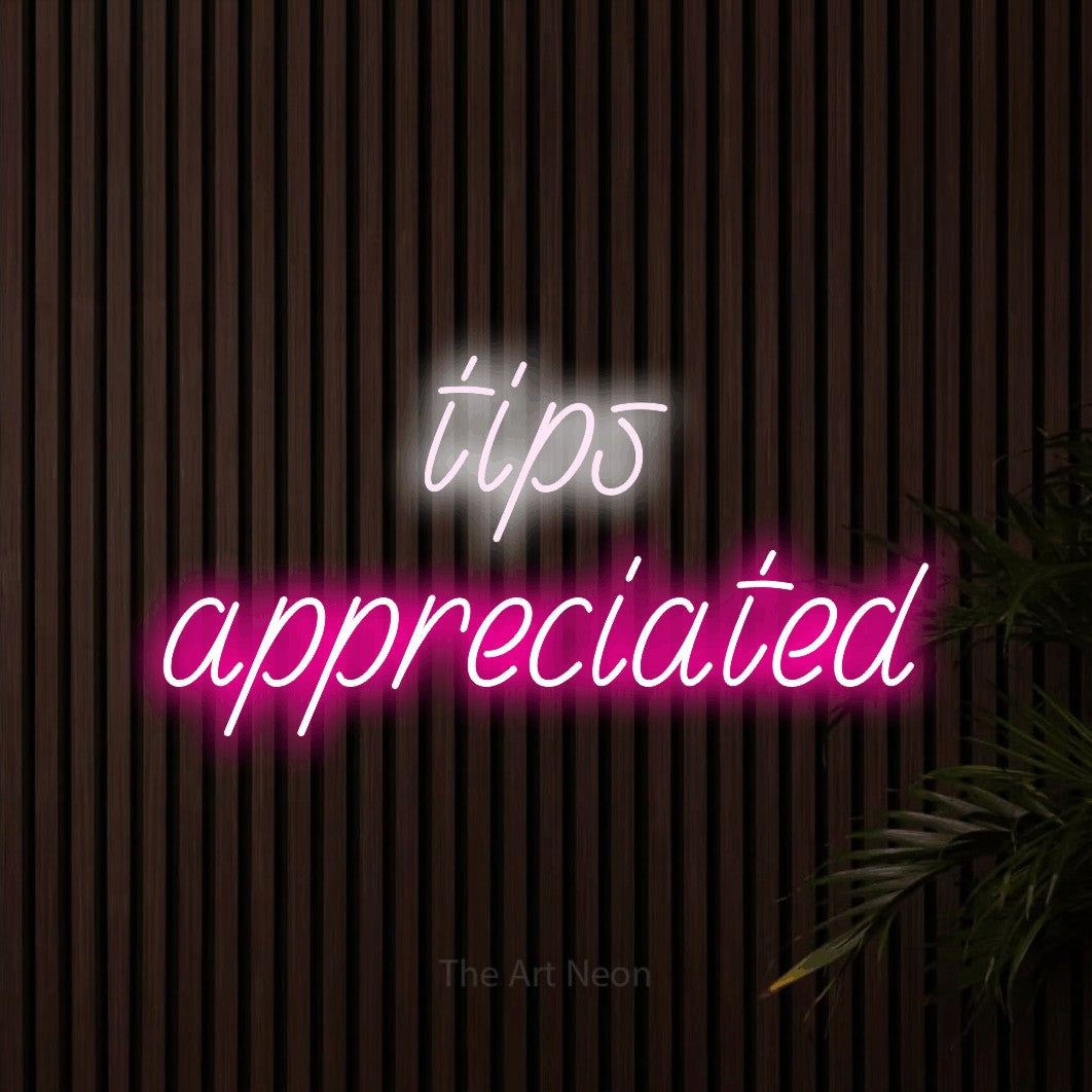 Hot pink and cool white LED neon sign reading "Tips Appreciated" against dark wooden slats for restaurant décor