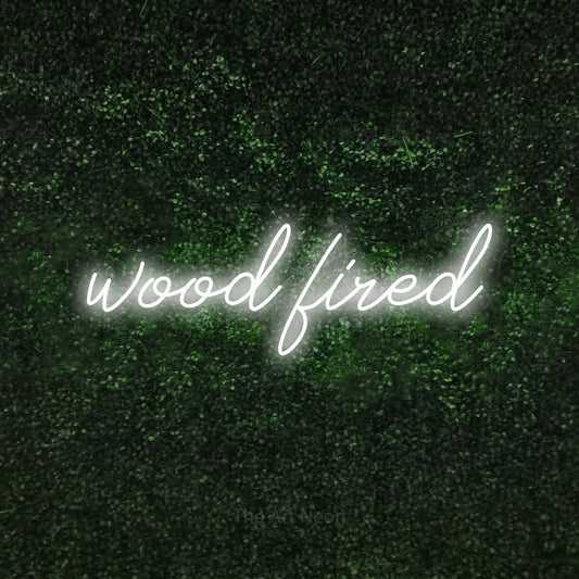 Cool white script-style LED neon sign reading "Wood Fired" against a textured green moss wall for restaurant décor