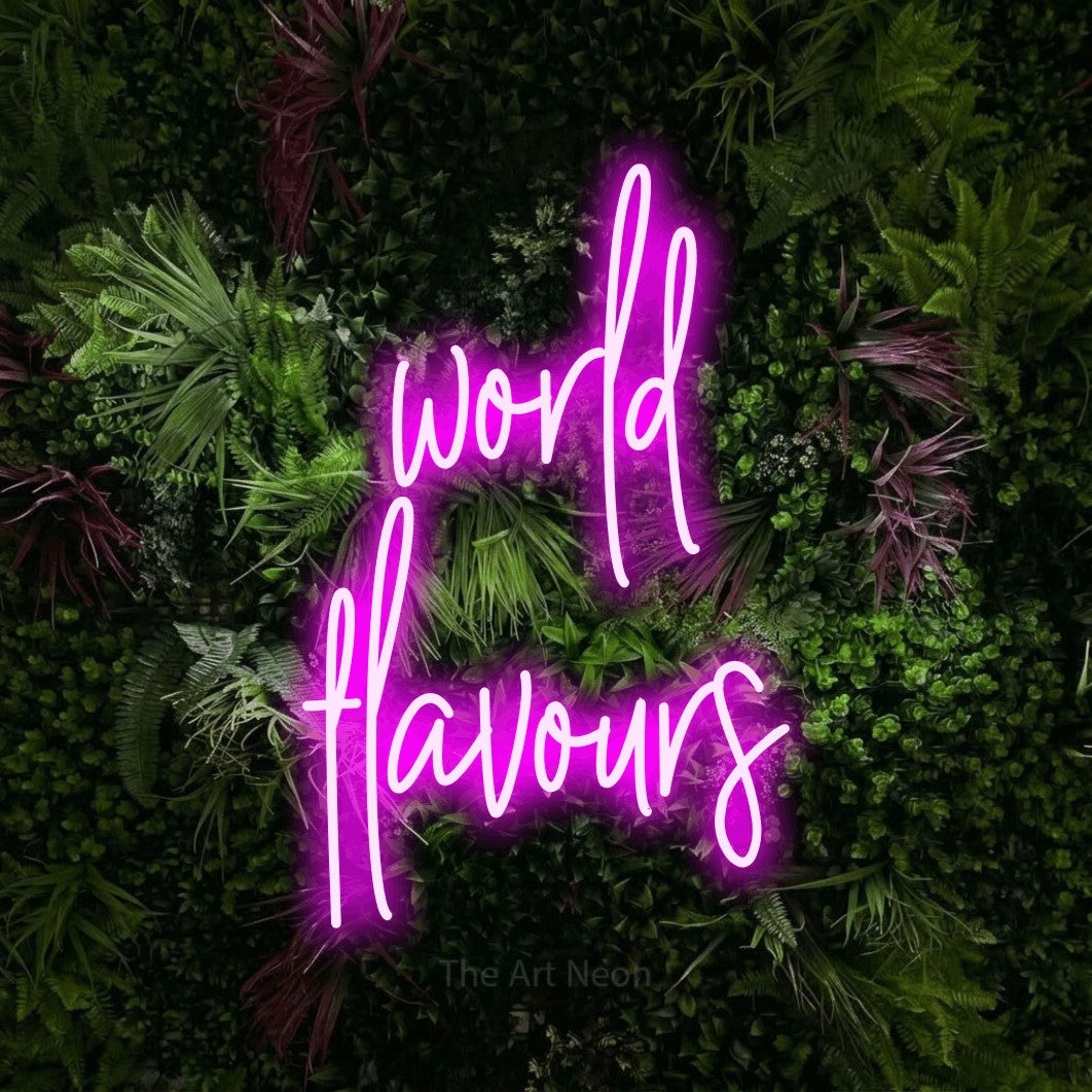 Pink script-style LED neon sign reading "World Flavours" against a lush garden wall with pink flowers for restaurant décor