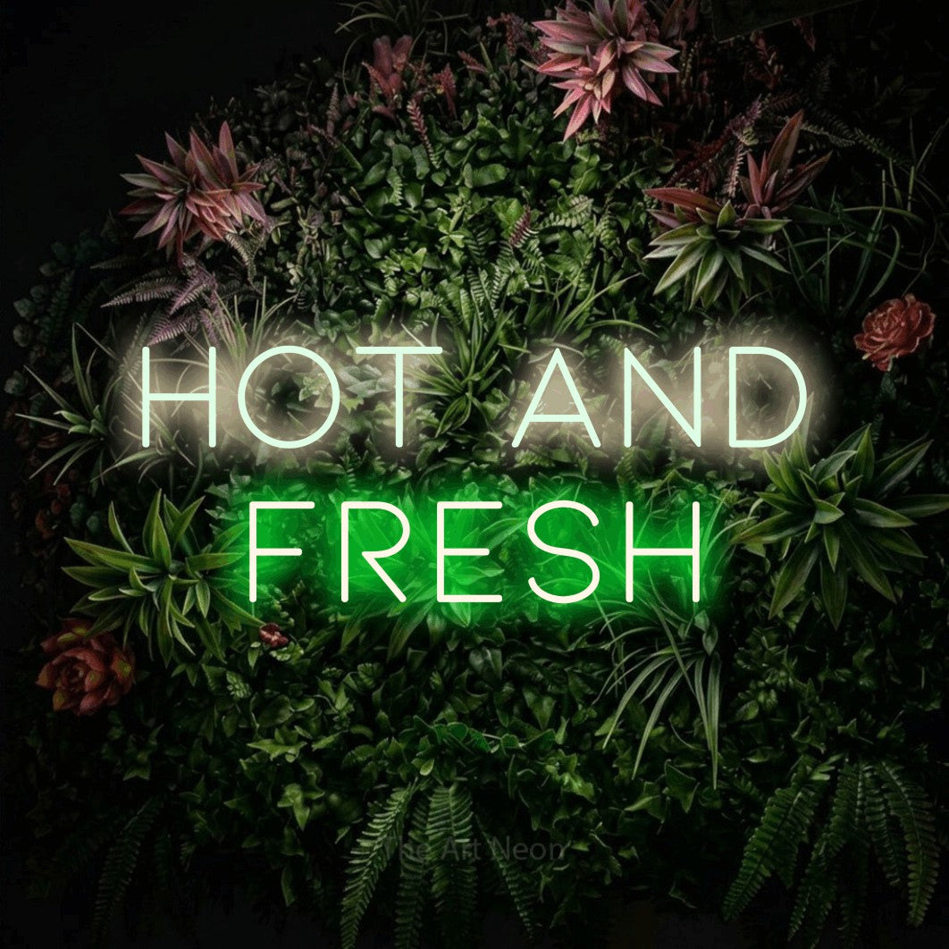 Green and warm white LED neon sign reading "Hot and Fresh" against a flowering garden wall for restaurant décor