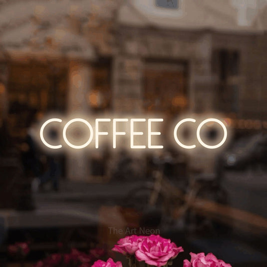 Warm white LED neon sign reading "Coffee Co" in a softly blurred café interior for café décor