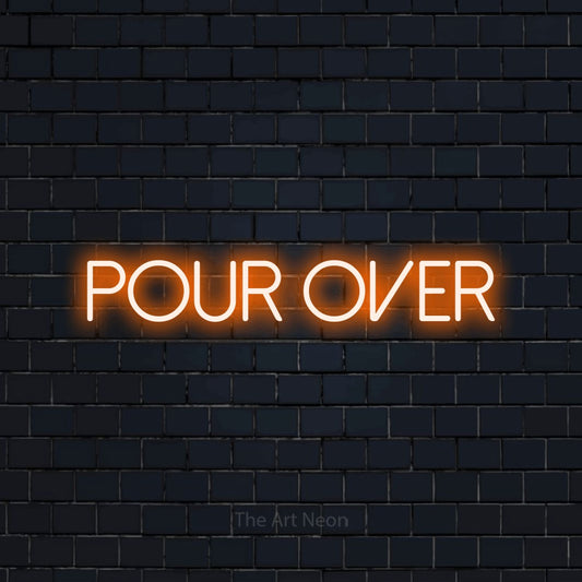 Orange LED neon sign reading "Pour Over" against a dark navy brick wall for café décor