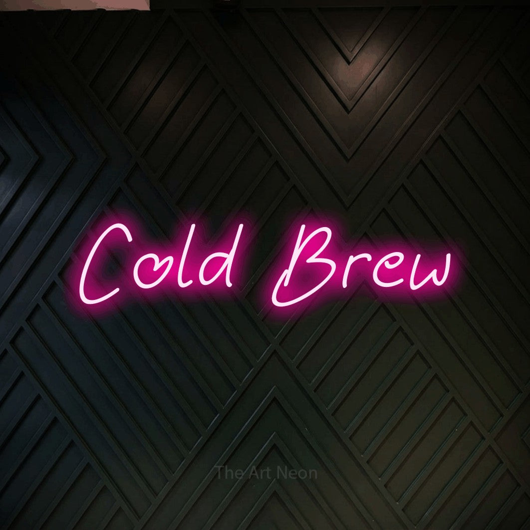 Hot pink LED neon sign reading "Cold Brew" against a dark geometric wood wall for café décor