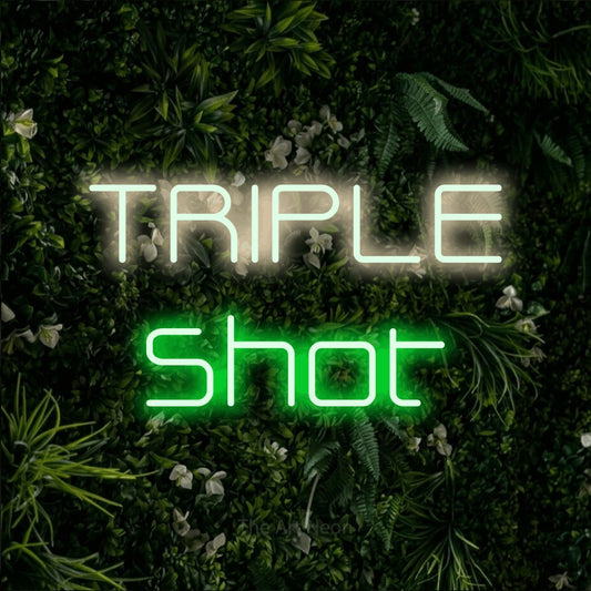 Green and warm white LED neon sign reading "Triple Shot" against a leafy green wall for café décor