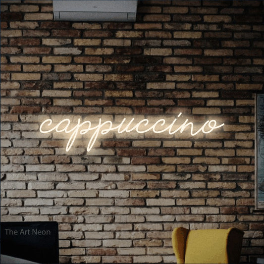 Warm white script-style LED neon sign reading "Cappuccino" against a rustic brick wall for café décor