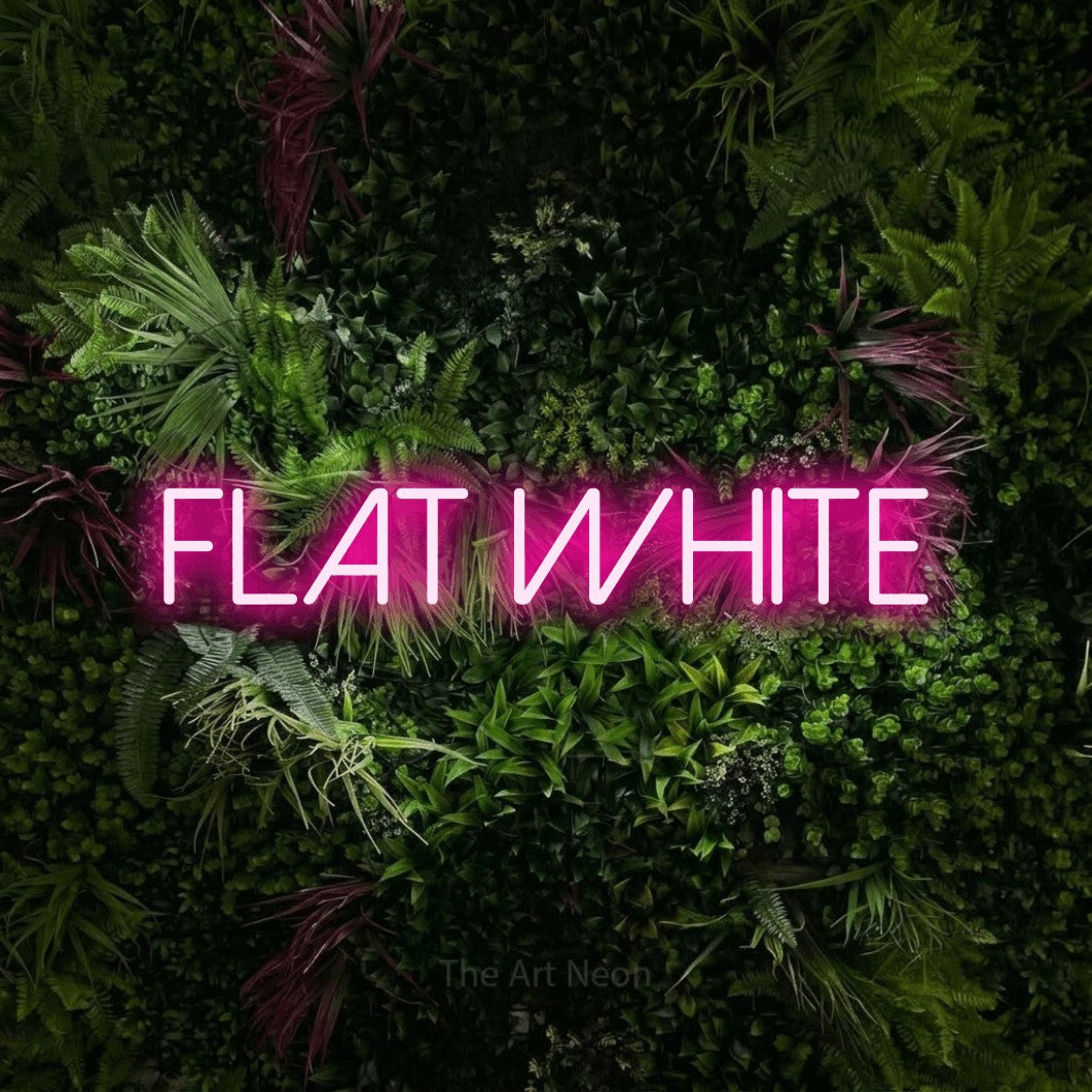 Hot pink LED neon sign reading "Flat White" against a lush garden wall with pink flowers for café décor