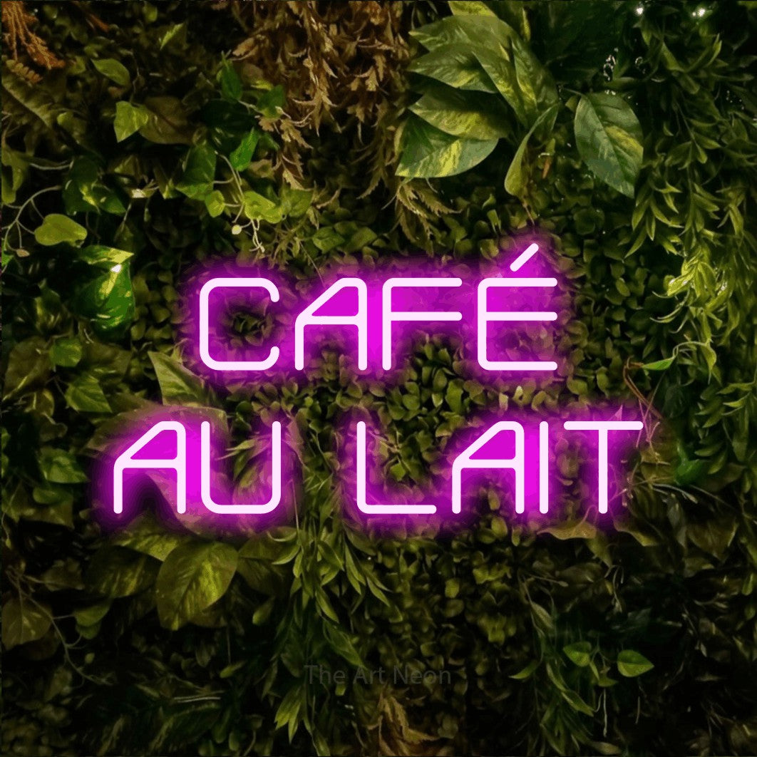 Pink LED neon sign reading "Café au Lait" against a textured moss and foliage wall for café décor