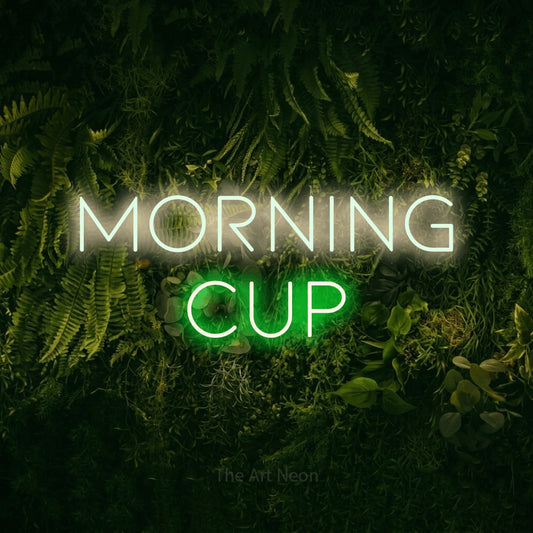 Green and warm white LED neon sign reading "Morning Cup" against a moss-covered green wall for café décor