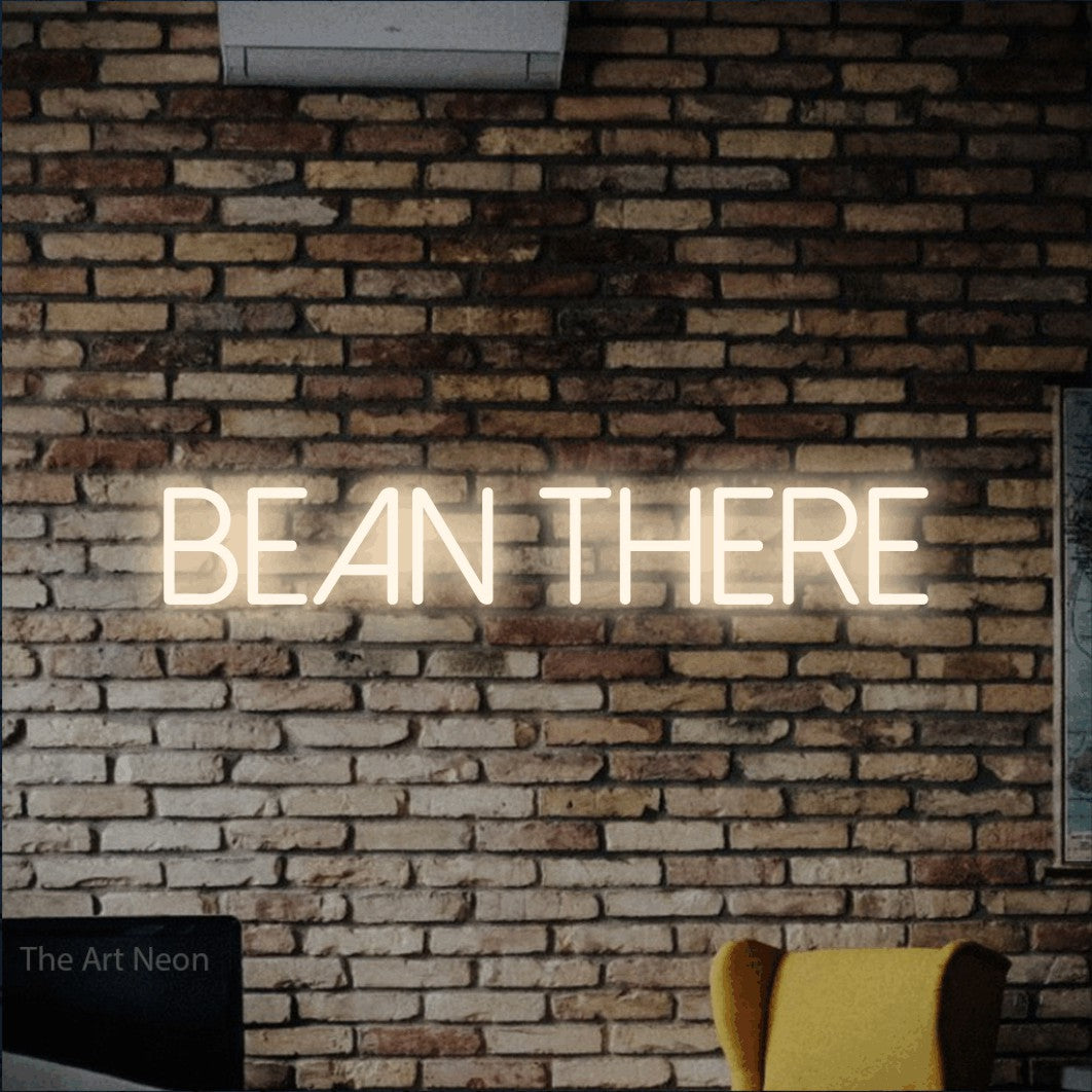 Warm white LED neon sign reading "Bean There" against a rustic brick wall for café décor