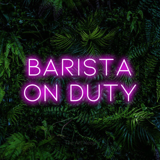 Pink LED neon sign reading "Barista on Duty" against a dense tropical foliage wall for café décor