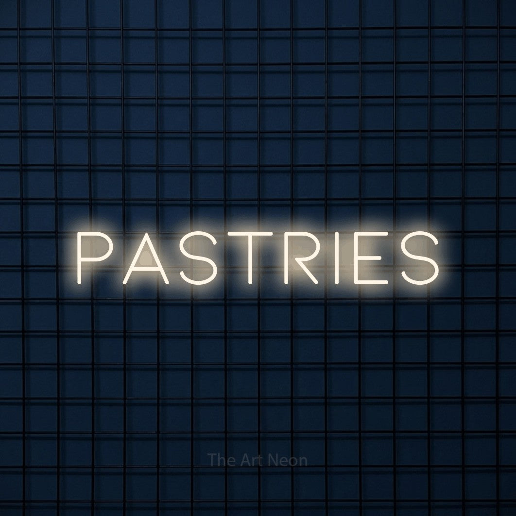 Warm white LED neon sign reading "Pastries" against a dark blue tiled wall for café décor