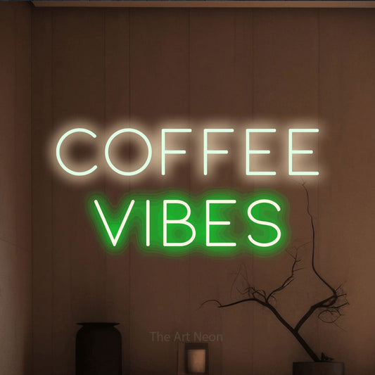 Green and warm white LED neon sign reading "Coffee Vibes" against a warm brown wall for café décor