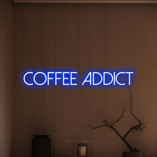 Blue LED neon sign reading "Coffee Addict" against a warm brown wall for café décor