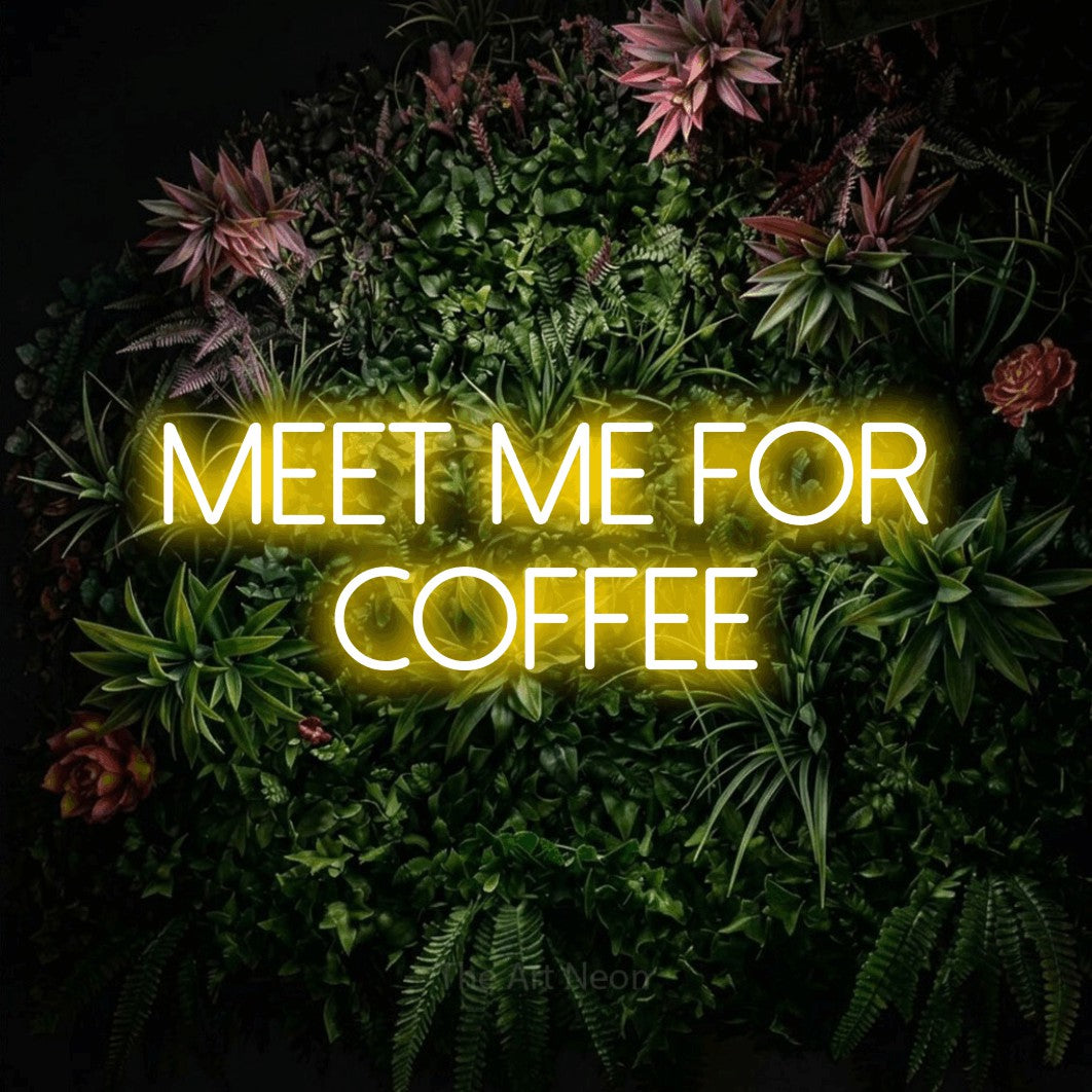 Yellow LED neon sign reading "Meet Me for Coffee" against a flowering garden wall for café décor