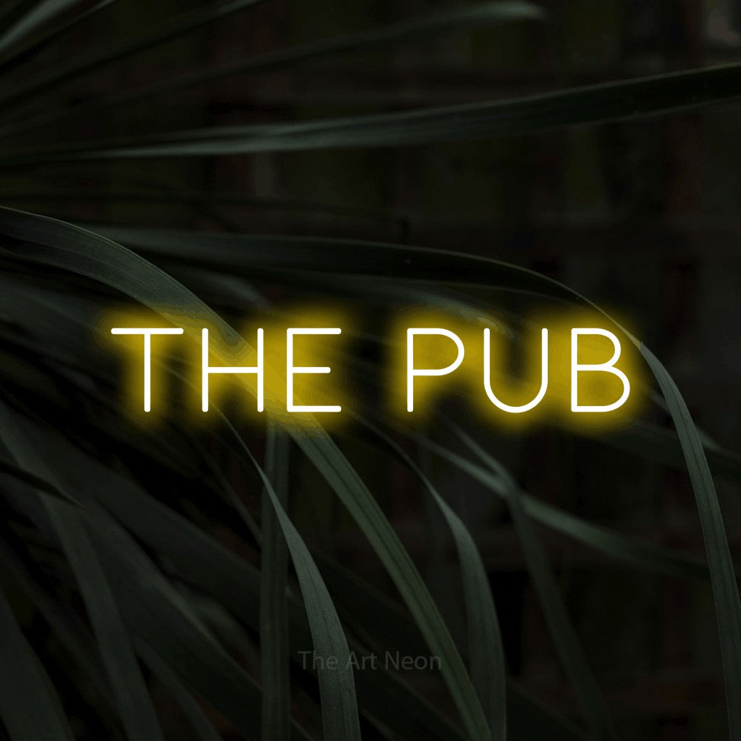 Yellow LED neon sign reading "The Pub" against dark tropical leaves for bar décor
