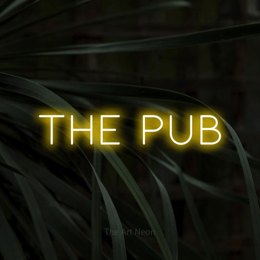Yellow LED neon sign reading "The Pub" against dark tropical leaves for bar décor